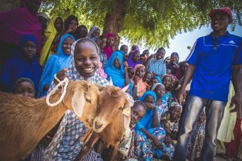 Rural Niger community and a young lady with goats.