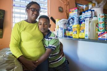 Aide, 45, and her son Luis, 12, purchased a variety of urgently needed supplies using their emergency cash card. PHOTO: Ezra Millstein/Mercy Corps