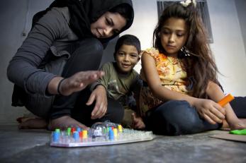 A young boy and girl playing a board game