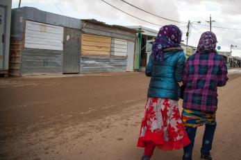 Image: Two girls walking from behind in Za'atari Camp for Syrian refugees