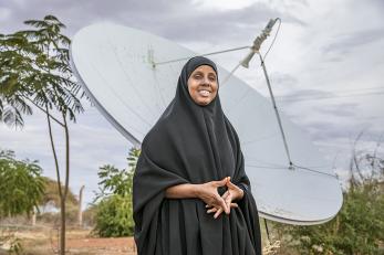 woman standing in front of a large satellite