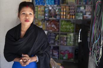 Woman in nepal standing in front of her store