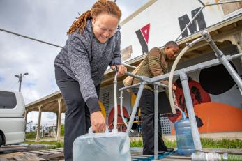 Bahamian filling water jug.