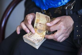 A persons hands counting cash money.