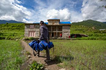 A health worker delivering COVID-19 kits to an isolation center in Jumla, Nepal.