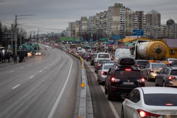 Residents and truck drivers seeking to leave the capital in a traffic jam in Kyiv, Ukraine. Photo credit: Erin Trieb/Bloomberg via Getty Images
