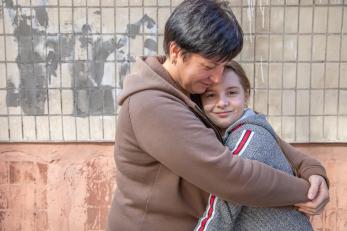 A parent hugs their daughter in Dnipro, Ukraine. 