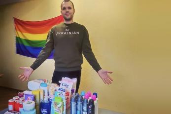 A person displaying personal care and hygiene supplies for displaced persons.