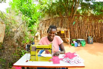 A person working on their sewing machine.