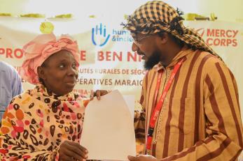 Participants at a Ben ni Baara event holding a document.