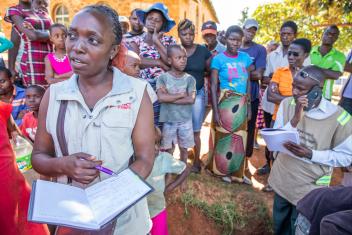 Mercy Corps’ Vimbayi Mazanhi helps to distribute jerrycans, water purification tablets, water storage buckets and soap to families taking shelter in a church in Ngangu, Zimbabwe. PHOTO: Ezra Millstein/Mercy Corps