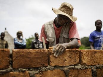 A man building a brick wall
