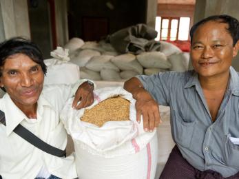 Kyi, pictured left, with a bag of rice
