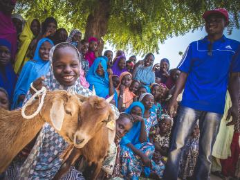 Rural niger community and a young lady with goats.