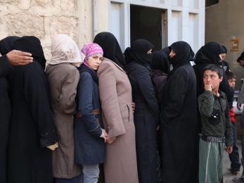Women in line for food baskets in syria