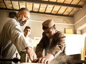 A young man participating in a carpentry class in afghanistan