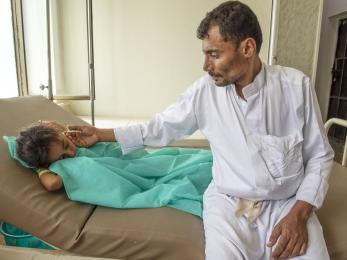 Abdullah sits with his 7-year-old daughter nehan as she receives treatment for cholera at a mercy corps-supported health clinic in yemen. more than 1 million cholera cases have been reported since april 2017. photo: ezra millstein/mercy corps