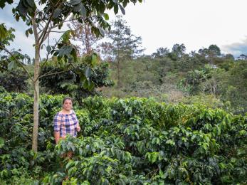 A land owner and farmer stand on their property in Colombia.