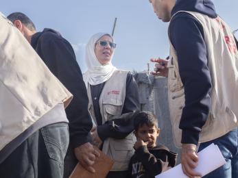Image of mercy corps aid worker among a group of other aid workers.