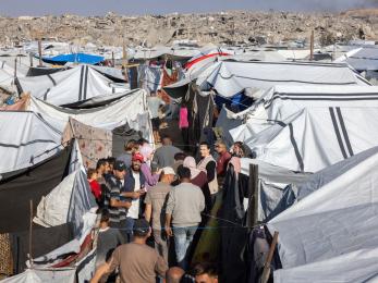 Scene of community members, among tents, in a displacement camp in northern gaza.