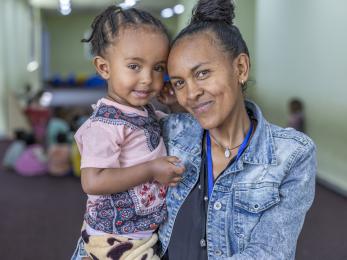 Ethiopian mother and daughter smiling together.